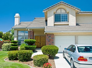 outside of a home with a silver car parked in the driveway